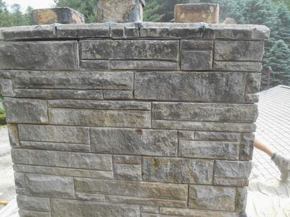 Stone chimney shown close up with stone work that needs repairing.