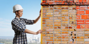 woman taking measurements of chimney bricks