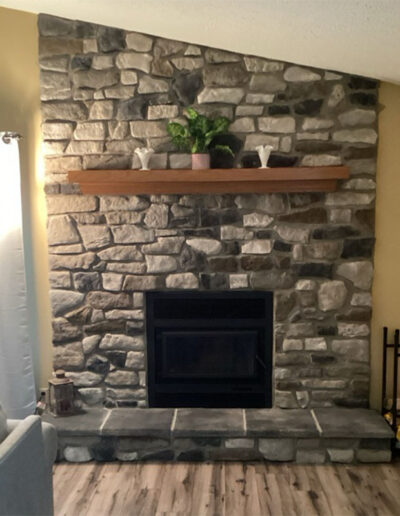 Fireplace makeover- new grey rock surround with wood mantelpiece