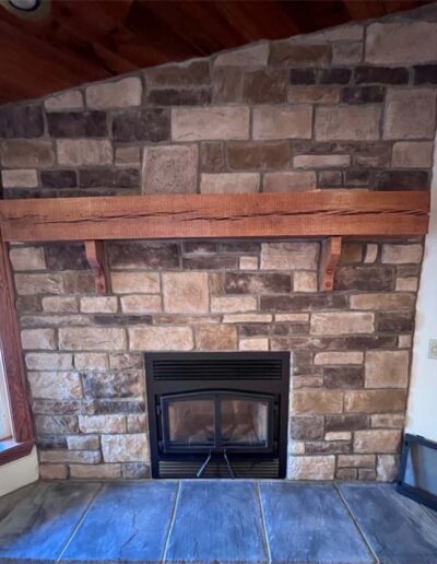 Fireplace makeover- new stone surround with wood mantelpiece